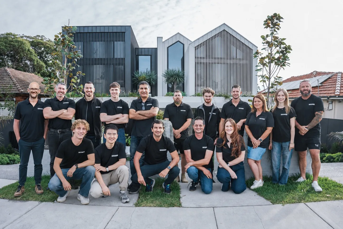 The Contour3D team in front of the Genesis 3D printed home